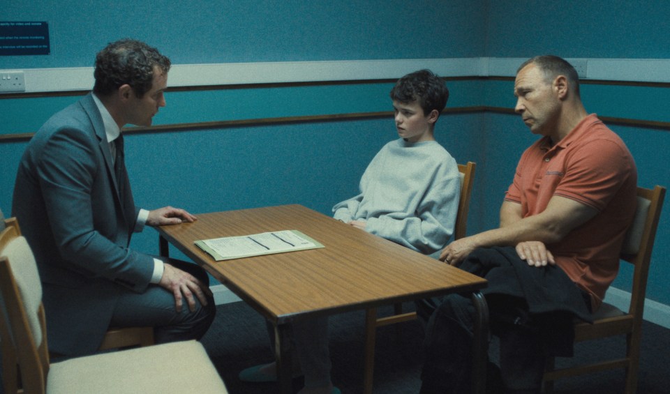 Scene from Adolescence showing three people sitting at a table.