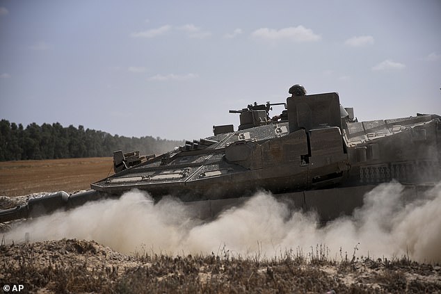 The Israeli military has recently stepped up its campaign in Gaza in what it says is a renewed push to defeat Hamas , whose October 2023 attack sparked the war. Pictured: Israeli forces move along the border with Gaza, in southern Israel, on May 19