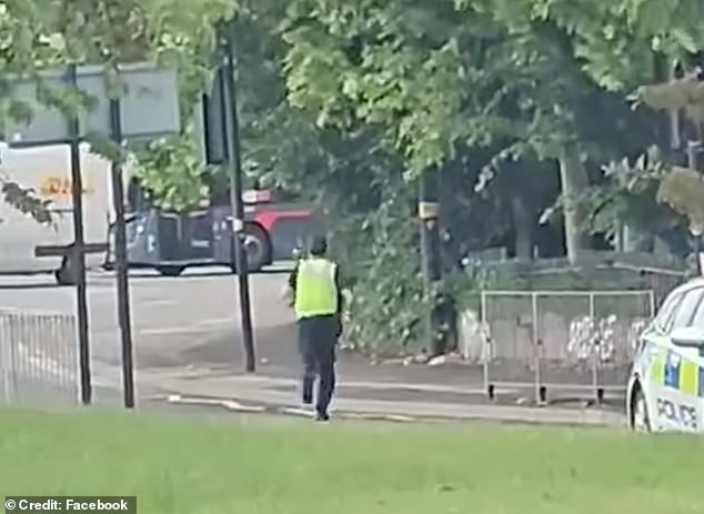 A policeofficer chases after the bull on the loose in Birmingham