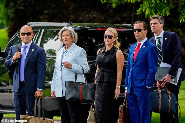 (L-R) Aide Walt Nauta, White House Chief of Staff Susie Wiles, White House press secretary Karoline Leavitt, Assistant to the President Sergio Gor, and an aide, wait for U.S. President Donald Trump to board Marine One on the South Lawn