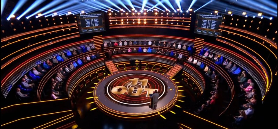 "11 Out" game show set with contestants.