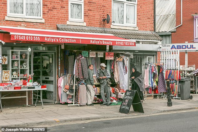 Pictured: Members of the public outside shop Aaliya's Collection and Beauty in Green Lane Road in Leicester yesterday