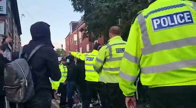 Police try to contain people at a march on Green Lane Road