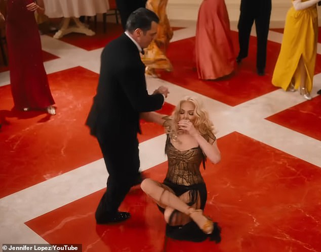 She was also seen in black as she danced with a man