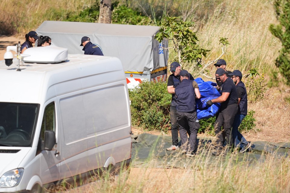 Officers packing up a tent during a search for Madeleine McCann.