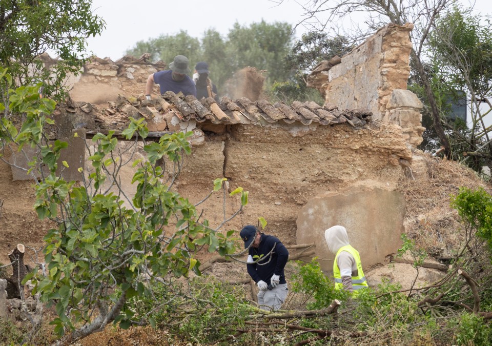 Police searching a dilapidated building and surrounding scrubland.