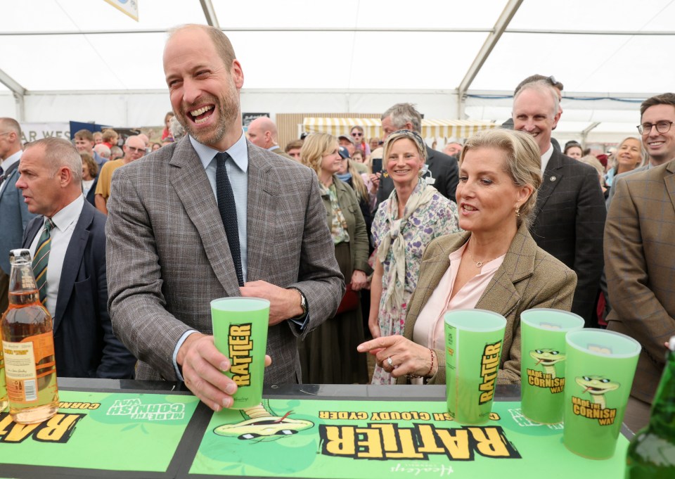 Prince William and Sophie, Duchess of Edinburgh, laughing while sampling cider at a food and farming event.
