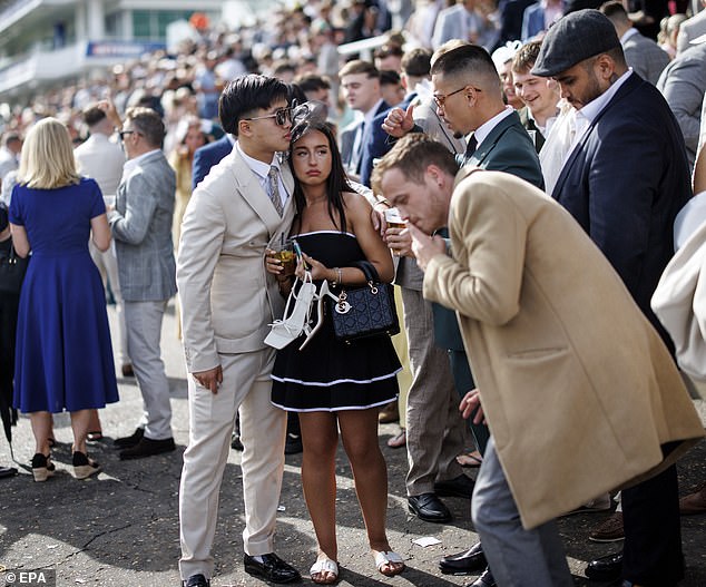 One woman switched into her flats and held her heels after many hours of watching the races