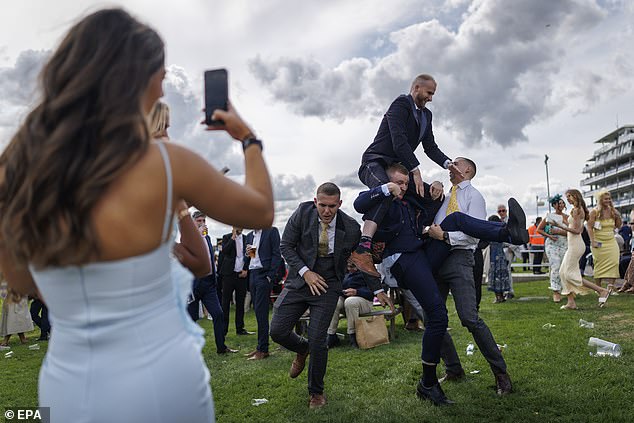 The fall guys: Moments after striking a pose, the men find themselves tumbling to the ground