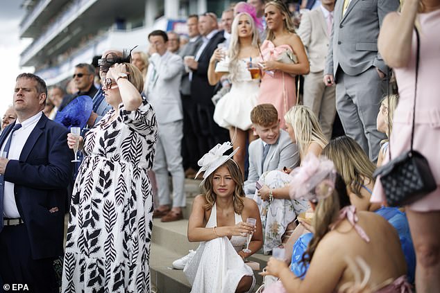 Donning an entire rainbow of bright colours, revellers braced a wet start and light rain for the opening day of the two-day festival