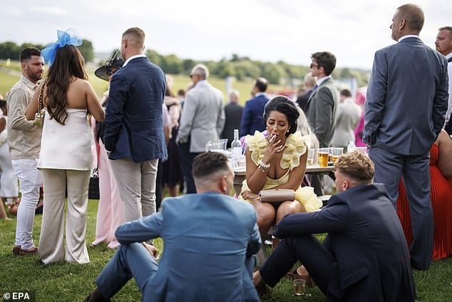 Racegoers take a break in between races as the annual event got underway on Friday