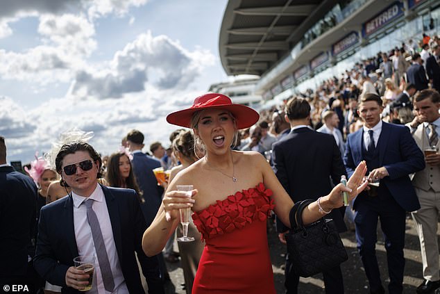 Lady in red: One visitor cuts a striking figure in a matching dress and hat