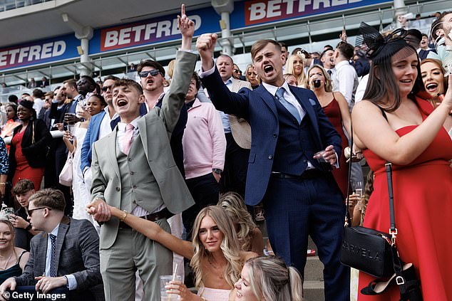 Cause for celebration: Scores threw their hands up in the air after their horses were victorious