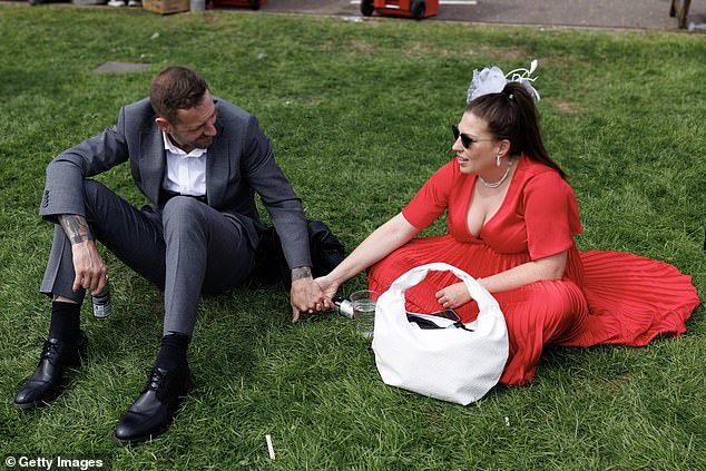 Holding hands: Racegoers enjoy the final moments of today's action at the racecourse