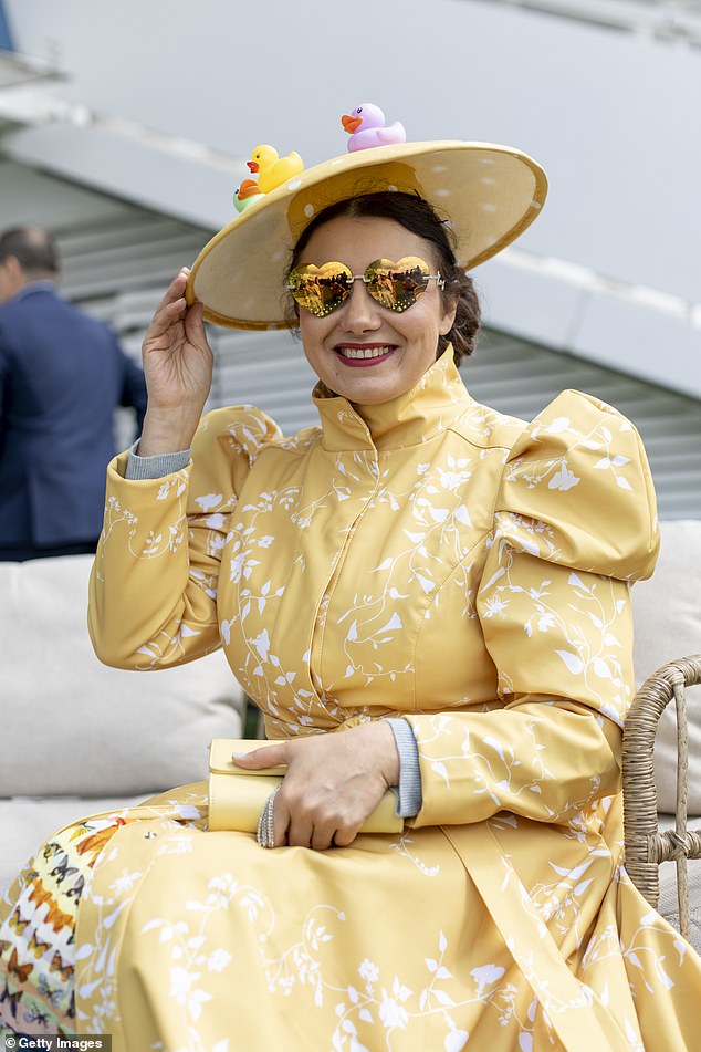 One woman dressed for the weather with a waterproof coat and rubber ducks on her hat