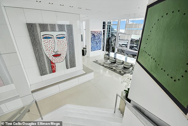 The multi-level penthouse sits in an asymmetrically gridded building. There are two fireplaces and multiple dining areas