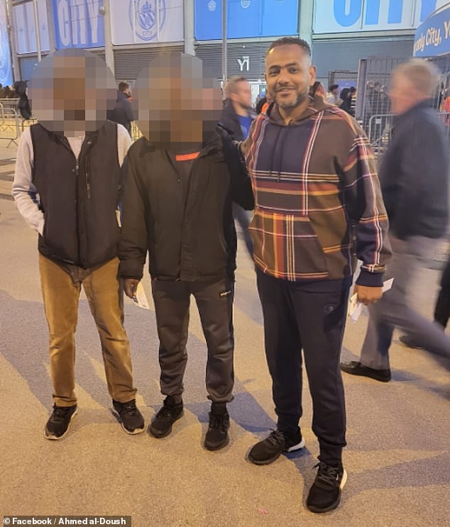Al-Doush (pictured here outside Manchester City's Etihad Stadium with two friends) has yet to meet his baby son who was born in December
