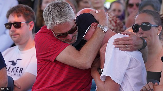 The family can¿t bring themselves to touch Barney¿s bedroom which is as it was on the day he returned to Nottingham for a cricket match at the end of the summer term two years ago, while his post piles up and remains unopened in the kitchen. Pictured: David and Charlie embrace during a vigil at the University of Nottingham
