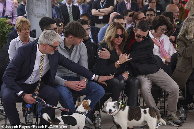 The family travelled to Nottingham the following day where they met Grace¿s parents for the first time at a vigil for their children. Pictured left to right: David Webber, Charlie Webber, Emma Webber, and Lee Coates, the son of Ian Coates, embrace during the emotional vigil