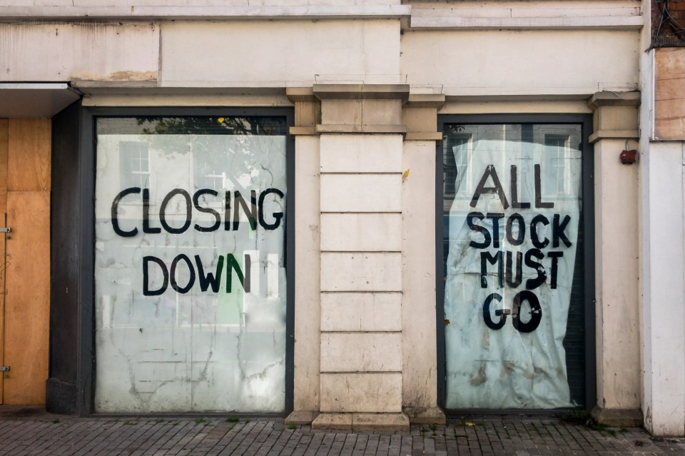 Closed shop windows with "Closing Down" and "All Stock Must Go" signs.