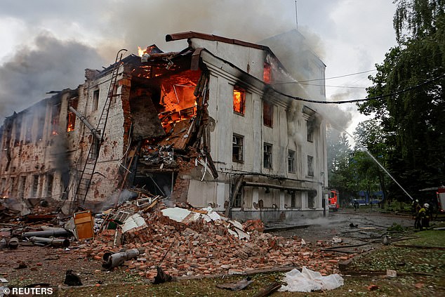 Firefighters work at the site of a building hit by a Russian drone strike