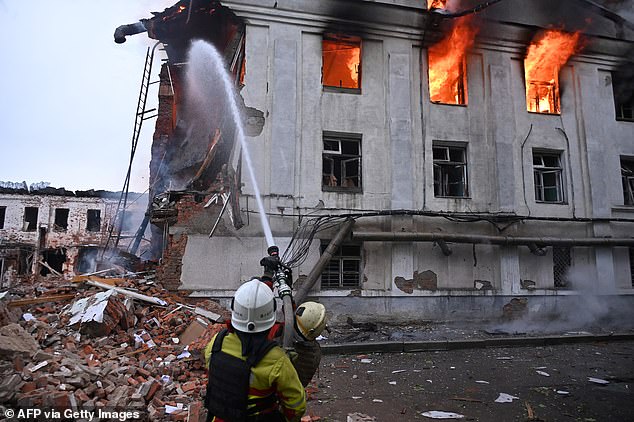 Firefighters extinguish a fire at a civilian plant following powerful attacks to Ukrainian city of Kharkiv early on June 7