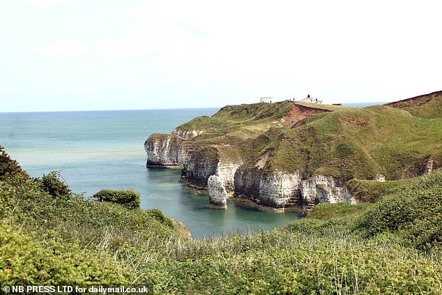 The striking glass-walled property is perched on the cliffs of East Yorkshire