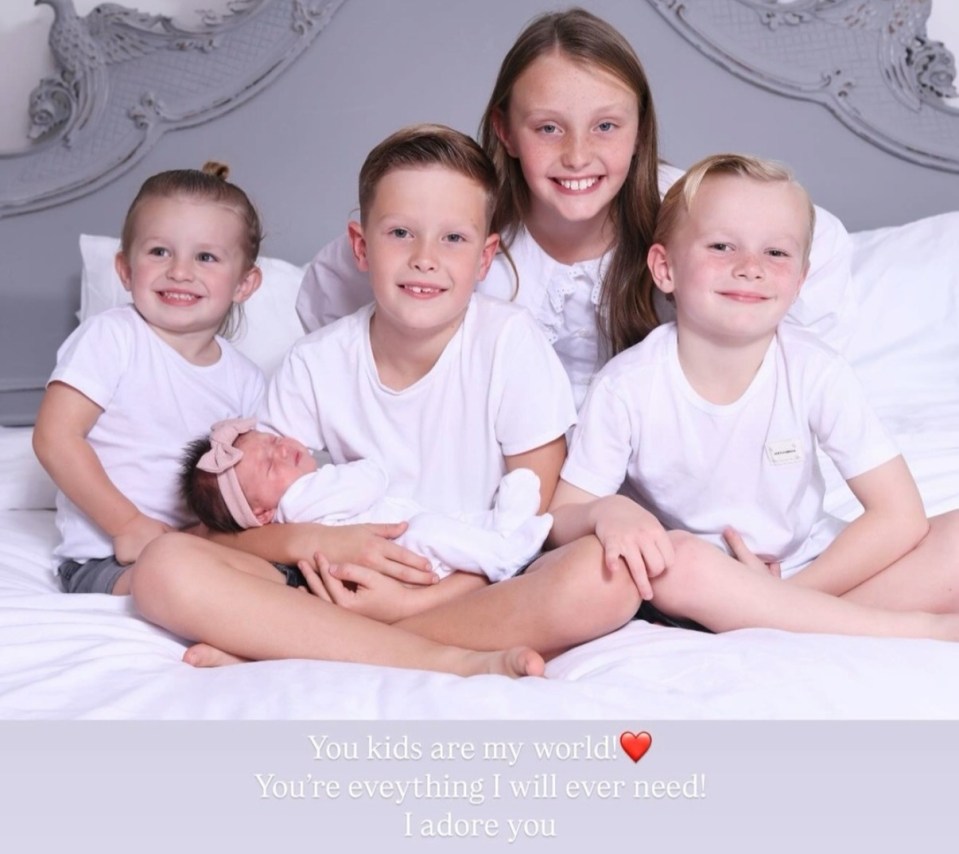 Photo of a mother with her four children, including a newborn baby.
