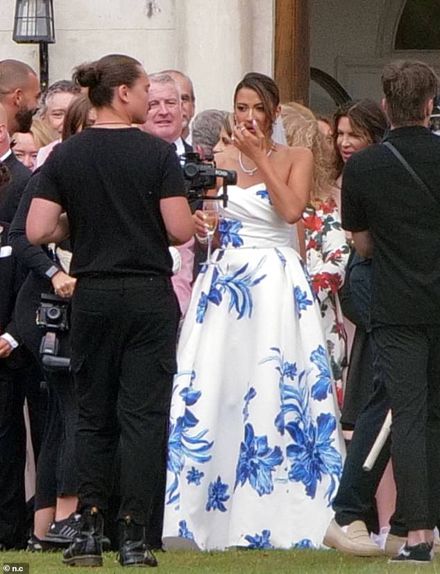 Meanwhile, the new Mrs Knowles was sure to turn heads as she opted for a quirky blue and white floral patterned gown for her big day