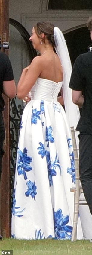 Katie donned a beaded white veil with her blue and white dress which featured a corseted back
