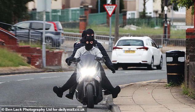 Balaclava-clad gangs tear through the roads on scooters, pulling reckless wheelies and shouting abuse at terrified passers-by on Bradford's notorious Holme Wood estate