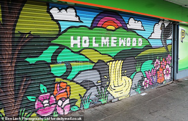 Burnt-out containers and graffitied shopfronts, near to where a 20-year-old man was stabbed in a suspected attempted murder, paint a bleak picture