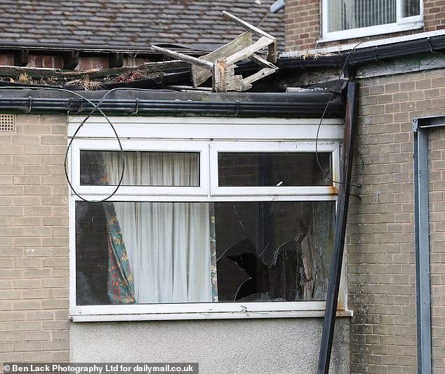 When MailOnline visited the area a smashed window was spotted with a seemingly broken chair left dumped on top of a building
