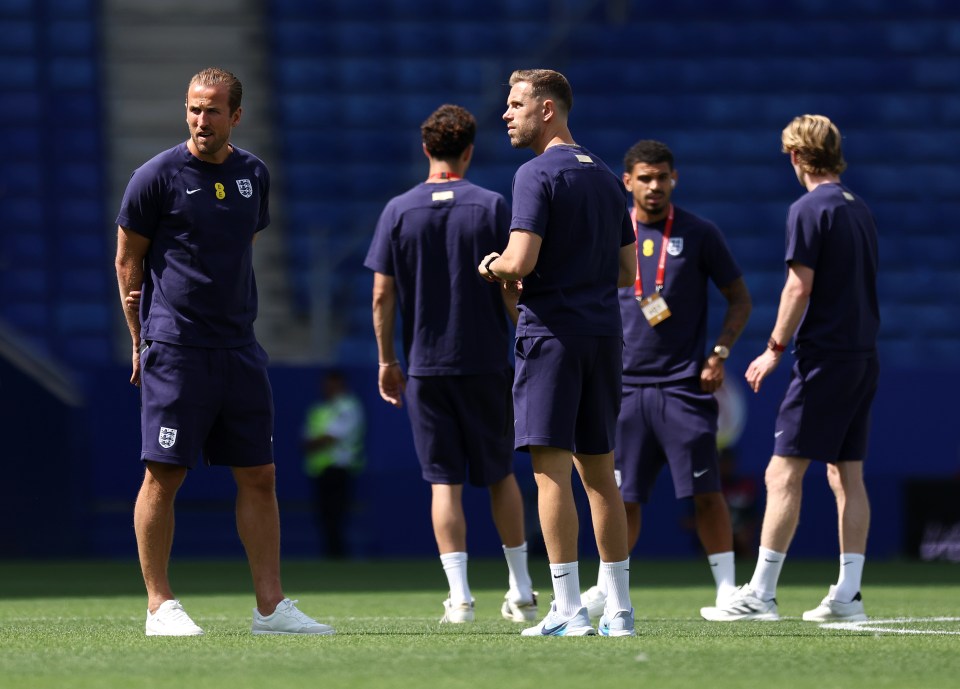 Harry Kane and Jordan Henderson of England inspecting the pitch.