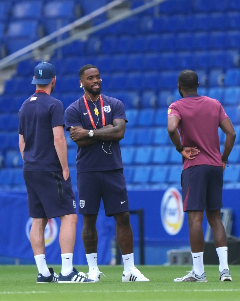 Ivan Toney and two other men on a soccer pitch.
