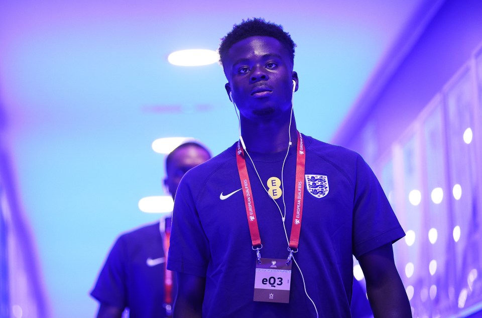 Bukayo Saka of England arriving at a stadium.