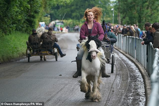 Visitors couldn't be putt off by the rain and ran their horses around the site as puddles formed and onlookers got soaked.