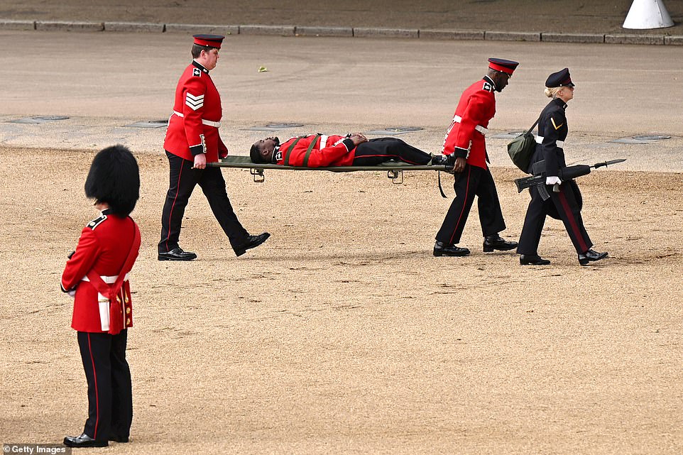 A member of the Household Division is carried away on a stretcher during The Colonel's Review 2025
