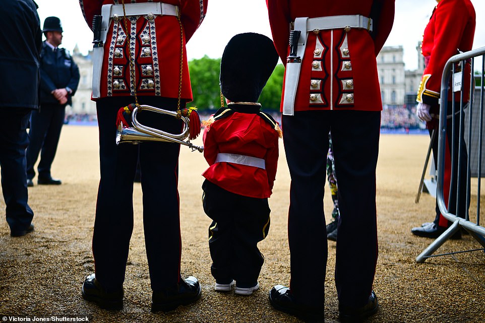 lexander Middleton, 3 years old, dressed up in uniform as he stands with soldiers ahead of The Colonel's Review