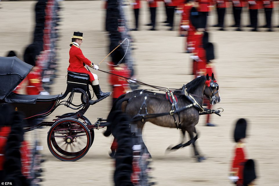 A royal carriage is drawn as regiments of the British Army's Household Division