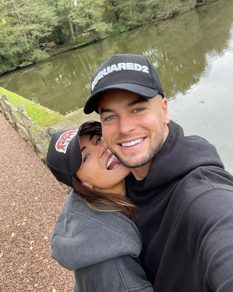 Chris Hughes and Annabel Dimmock embracing near a pond.