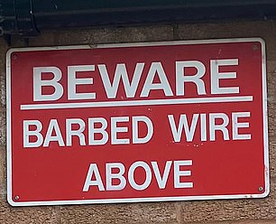 The first of the signs fixed to a 'community centre'