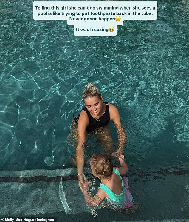 As Molly and Bambi swam in the pool she penned: 'Telling this girl she can't go swimming when she sees a pool is like trying to put toothpaste back in the tube. Never gonna happen'