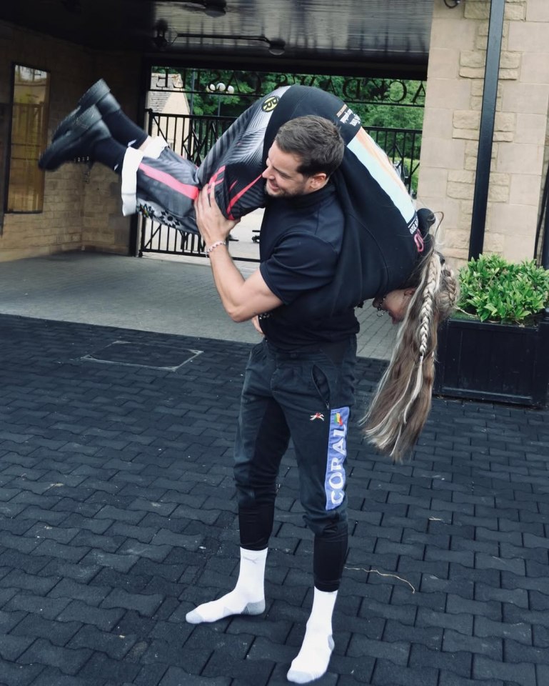 Man carrying a woman on his shoulders.
