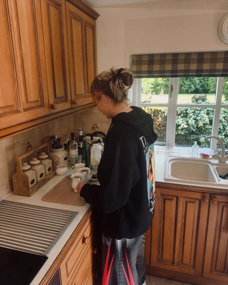 JoJo Siwa making coffee in a kitchen.