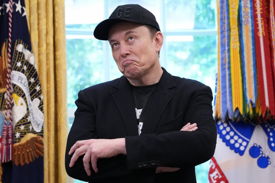 Elon Musk with arms crossed in the Oval Office.