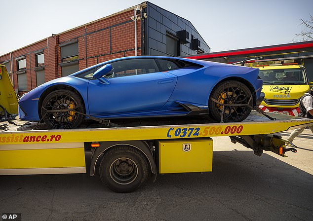 Pictured: Police seizing a Lamorghini car from Andrew Tate's residence in Romania on August 24, 2024