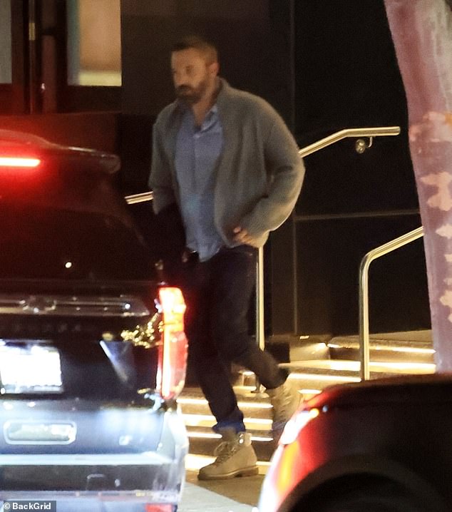 The Oscar winner looked relaxed, wearing a thick gray sweater over a blue button down shirt and dark jeans tucked into his beige ankle boots. His dark hair and beard were closely trimmed