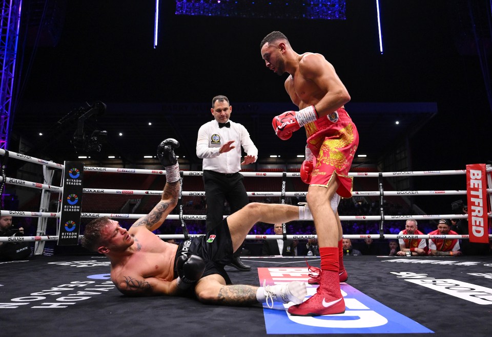 A boxer falls to the canvas during a boxing match.