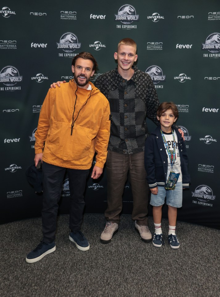 Three people at the Jurassic World: The Experience event.